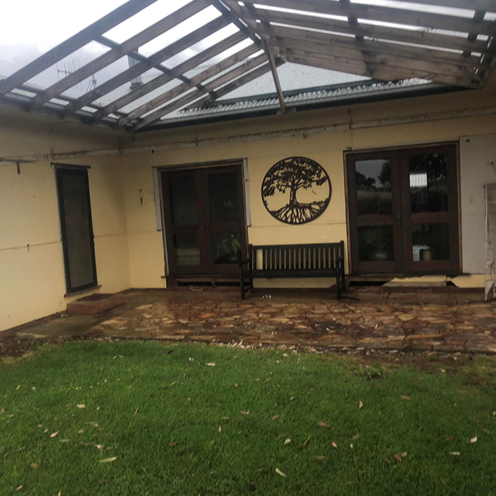 Before: old pergola over a paved courtyard behind a house
