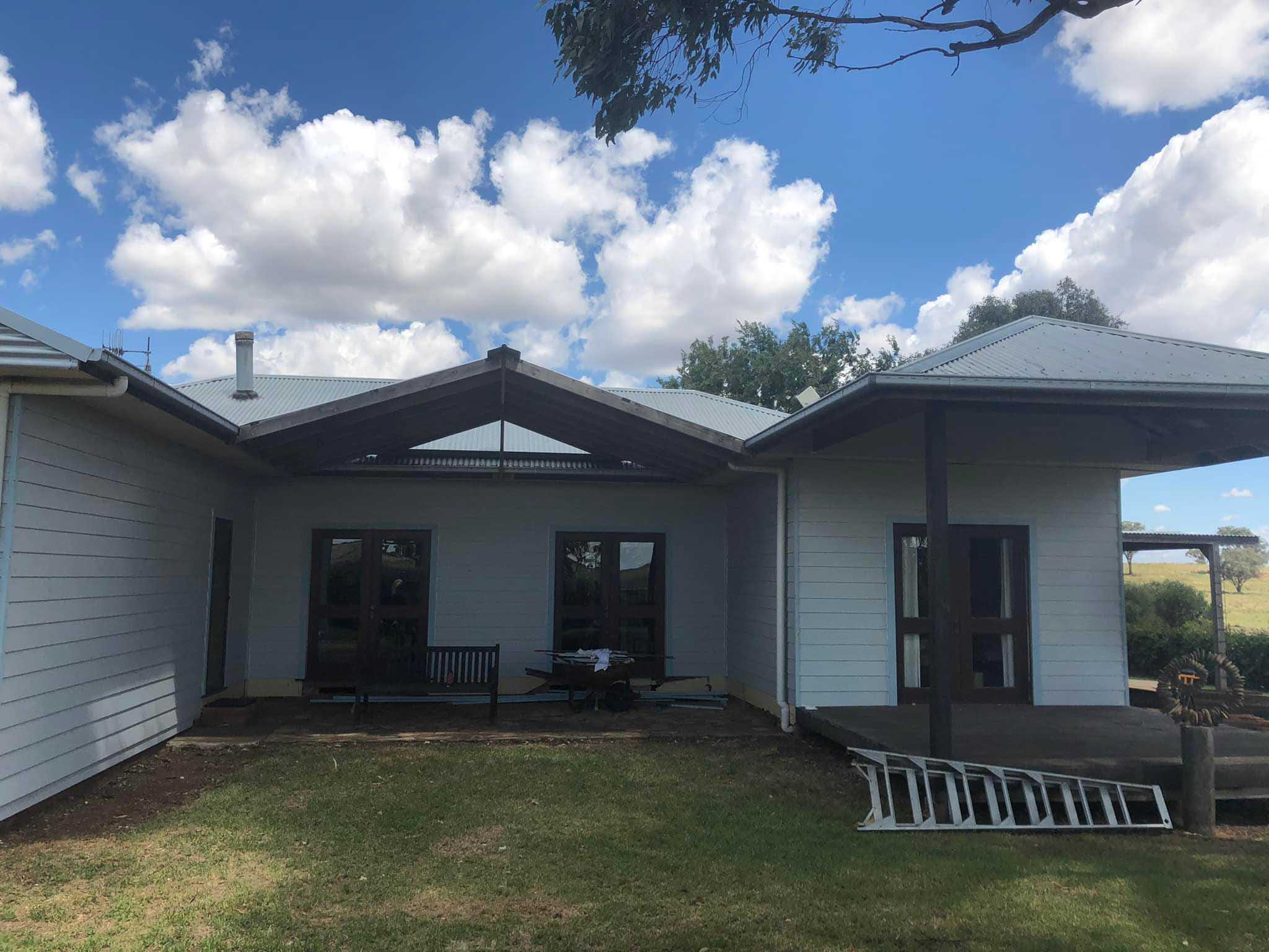 Weatherboard house with a gabled roof over the back courtyard