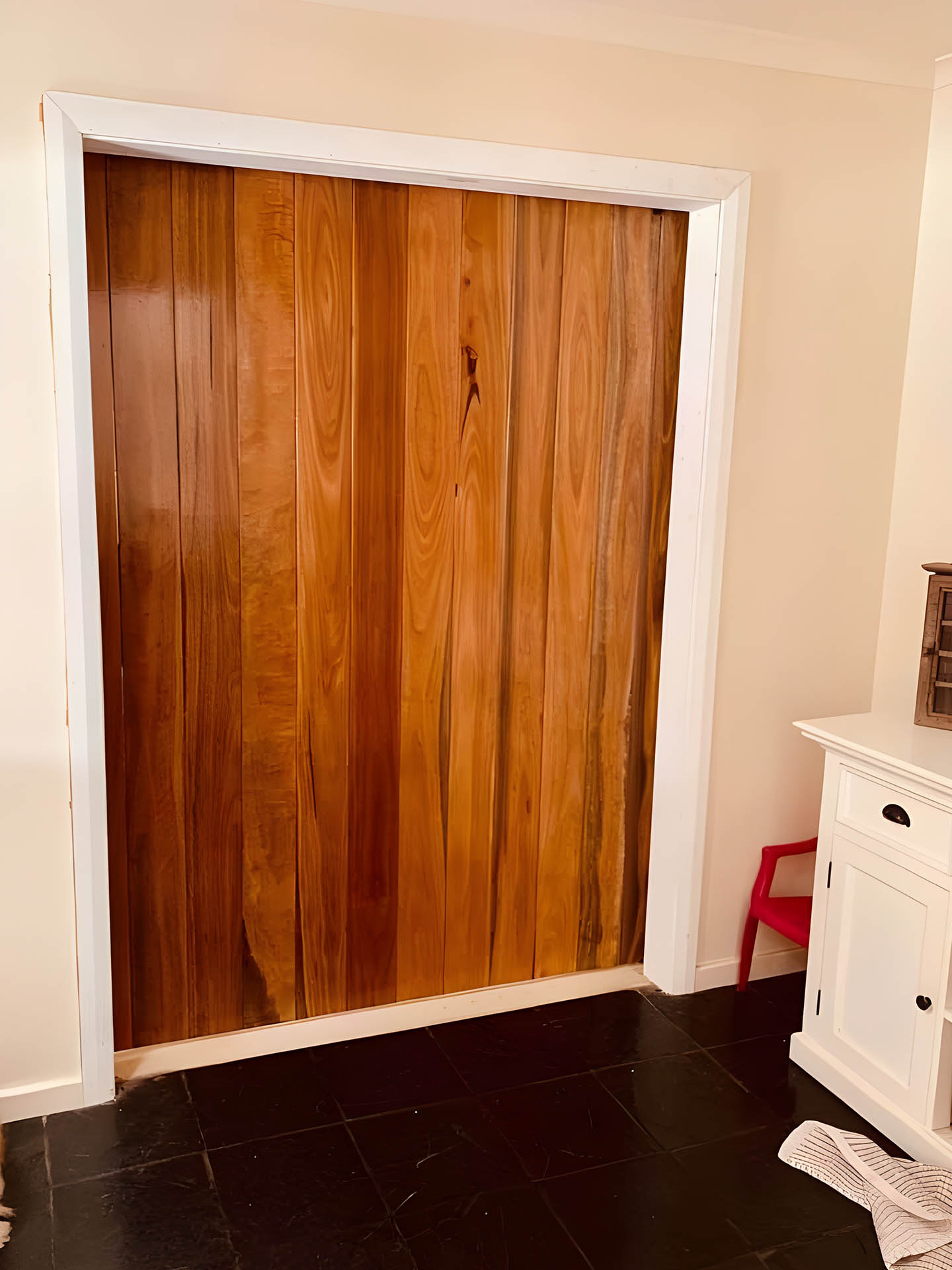 Tall timber doors fitted in a white-framed doorway
