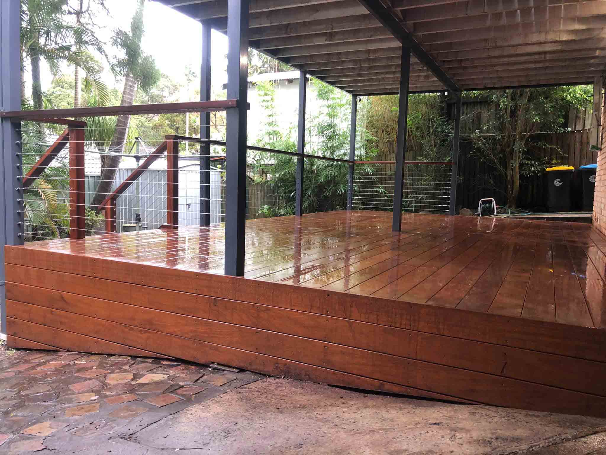 Raised timber deck with a timber-clad base under a pergola