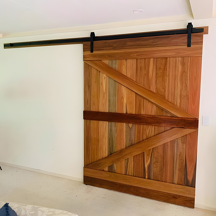 After: timber barn door on a black sliding track