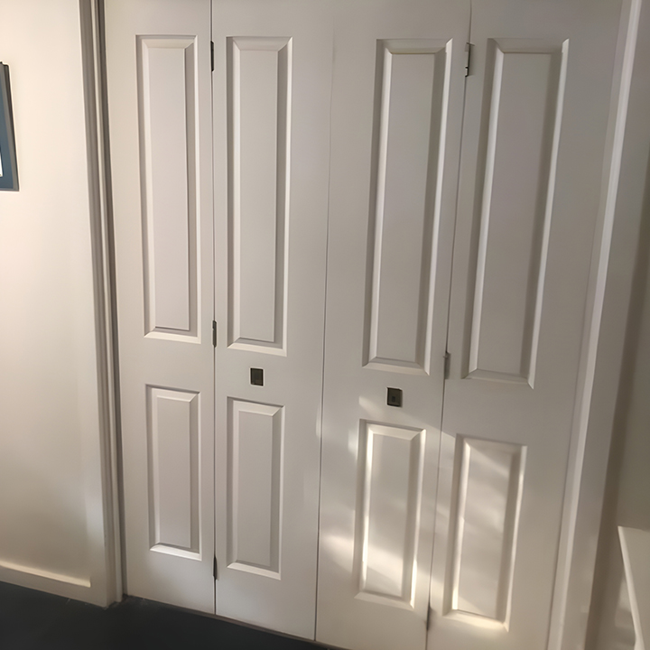 Before: white panelled bifold wardrobe doors