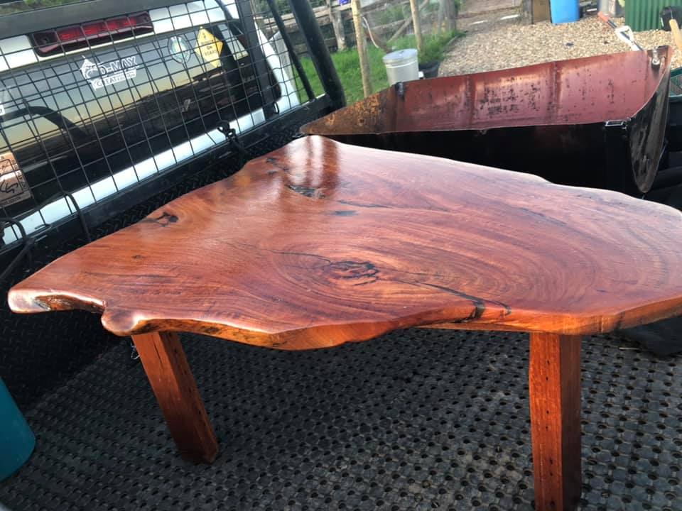 Live-edge timber slab table on the tray of a ute