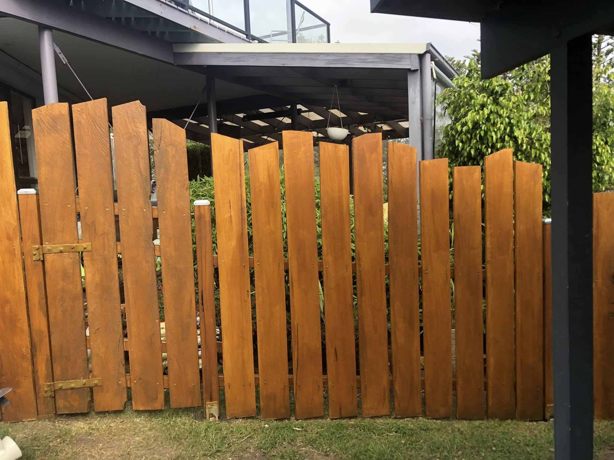 Timber paling fence and gate between two houses