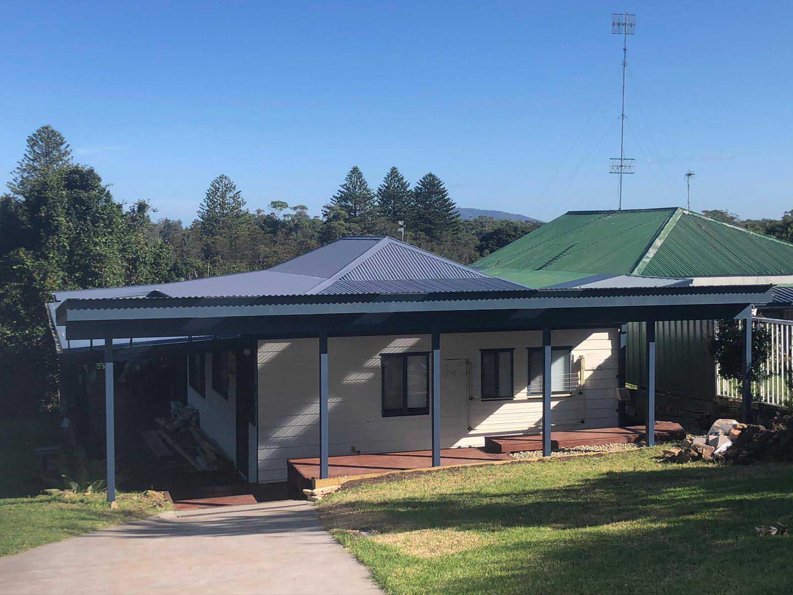 Long covered verandah with a timber deck across the front of a house