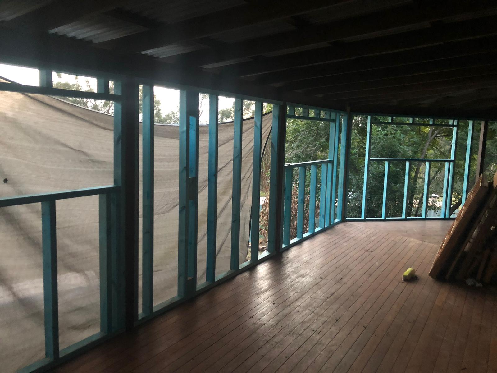 Steel wall frames enclosing a timber-floored verandah